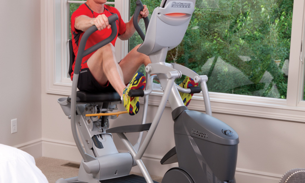 man working out on home elliptical